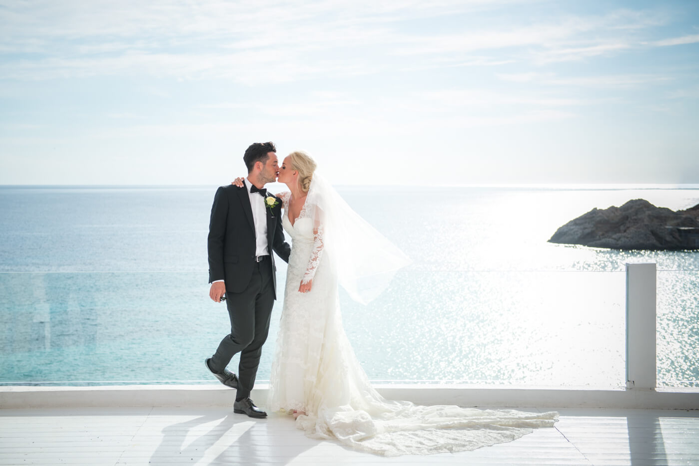 gypsy westwood photography, newlyweds kissing with Mediterranean in background