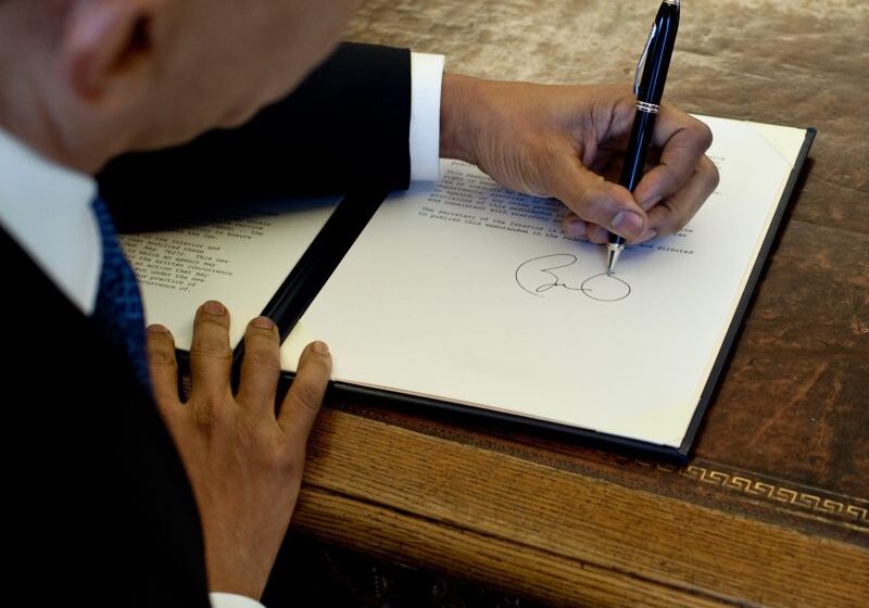 President Barack Obama writes at his desk in the Oval Office 3/3/09. 
Official White House Photo by Pete Souza