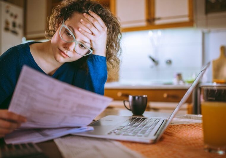 a woman frustrated with invoices