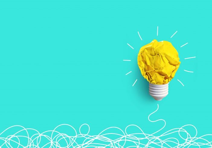 Creativity inspiration,ideas concepts with lightbulb from paper crumpled ball on pastel color background.Flat lay design.
